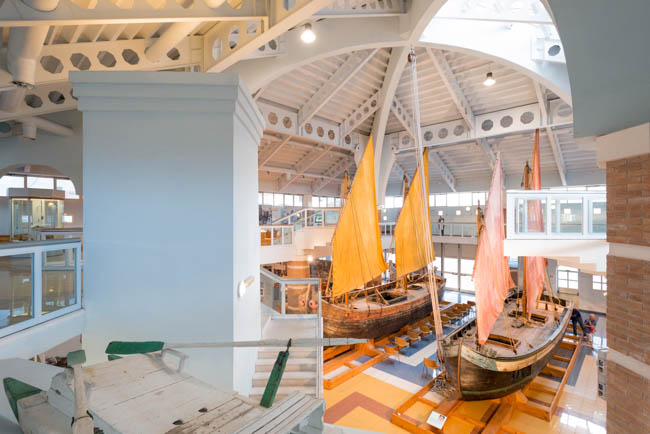 Inside the Maritime Museum of Cesenatico, with historic boats and their sails raised